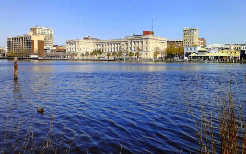 City skyline with historic buildings and waterfront view.