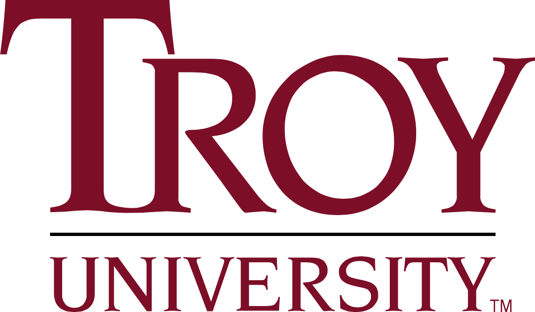 A scenic view of Troy University campus with buildings and greenery.